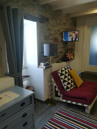 a living room with a couch and a window at A Tasca in Vila Real