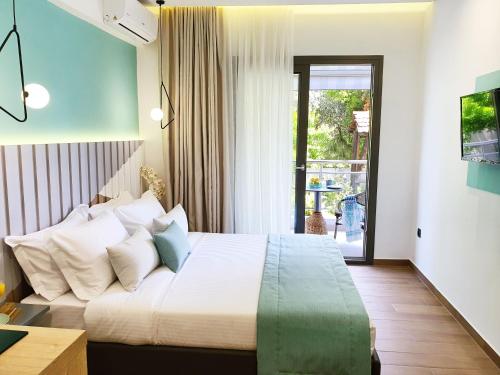 a bedroom with a large bed with white pillows at Villa Sofia Fresh in Limenaria