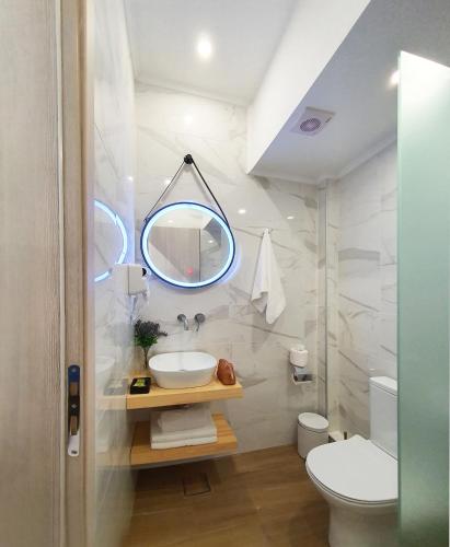 a bathroom with a sink and a mirror at Villa Sofia Fresh in Limenaria