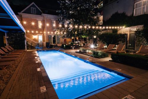 a swimming pool with lights on a building at night at Hotel Ella in Austin