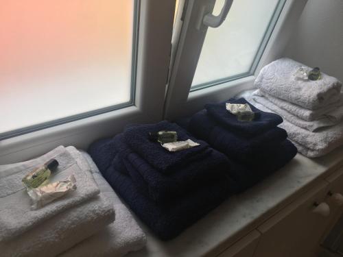 a pile of towels sitting on a counter next to a window at La Finestra sul Mare in Lerici