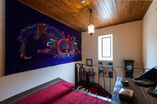 a room with a large painting on the wall at Quinta da Tapada in Avô