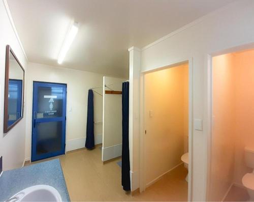 a bathroom with a sink and a toilet at Tongariro River Retreat in Turangi