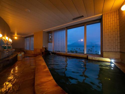 a large indoor swimming pool in a hotel room at Hotel Welview Kagoshima in Kagoshima