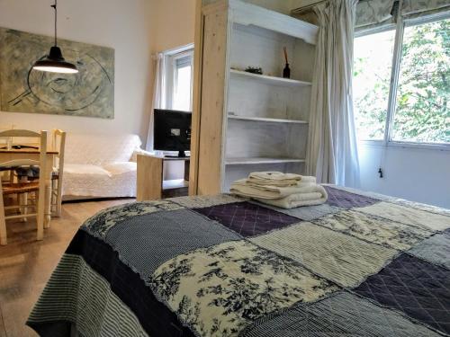 a bedroom with a bed with towels on it at Amazing Studio in Recoleta in Buenos Aires