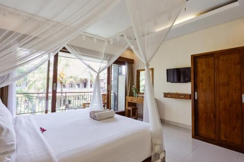 Postel nebo postele na pokoji v ubytování Outpost Ubud