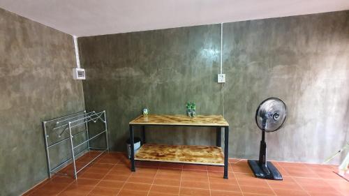 a bathroom with a shower with a fan at Moonshine Resort Chumphon in Chumphon
