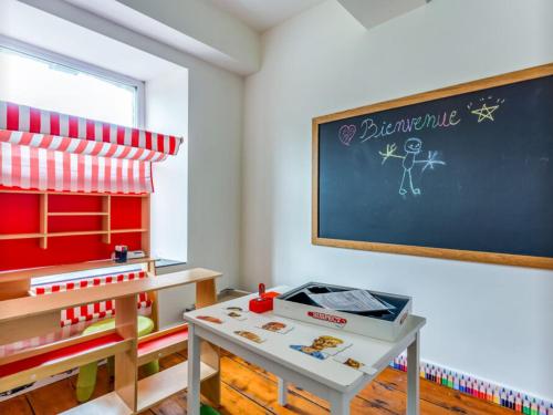 a classroom with a desk and a chalkboard at Petit Château de Harzé in Aywaille
