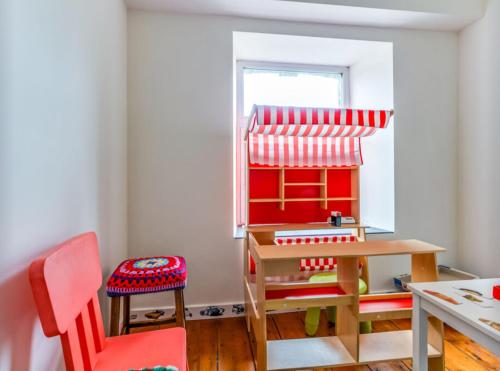 a toy room with a table and a chair at Petit Château de Harzé in Aywaille