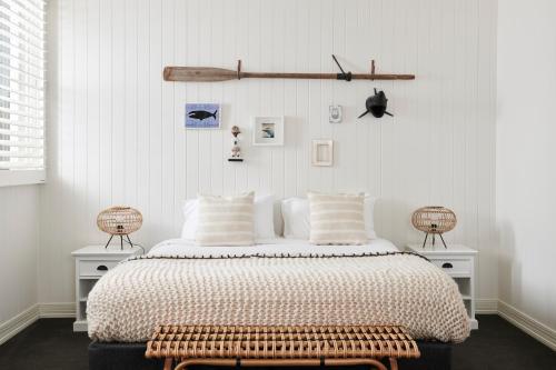 a bedroom with a bed with a bench next to it at Anchor Geelong in Geelong