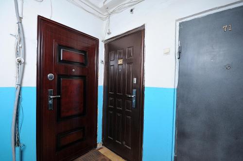 two doors are shown next to each other in a room at Omsk Sutki Apartments on Mira 10 in Omsk