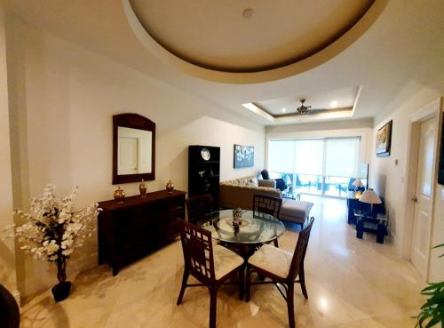 a living room with a table and chairs and a couch at Landmark by Villas Segovia in Cozumel