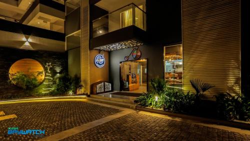 a building with a sign on the front of it at Kent Baywatch Suites in Cochin