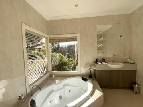 a large bathroom with a tub and a sink at Delderfield Villas & Massage in Marysville