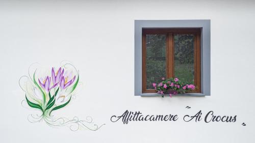 a window sill with a flower pot on a wall at Affittacamere Ai Crocus in Cesclans