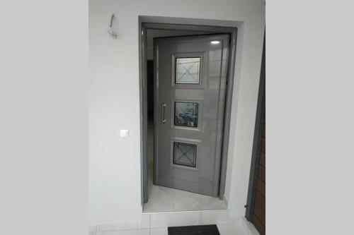 a gray door in a hallway with a tile floor at Arxontia 1 in Kalamata
