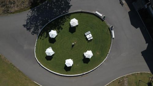 an overhead view of a park with umbrellas at Fredensborgs Herrgård in Vimmerby