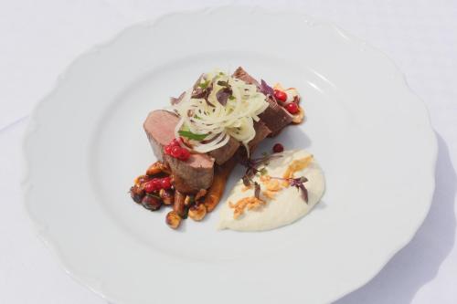 a plate of food with meat and a dessert at Fredensborgs Herrgård in Vimmerby
