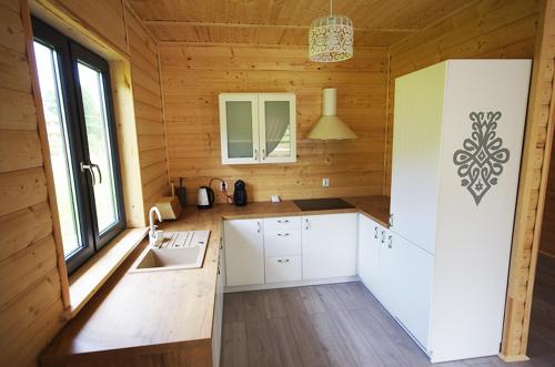 a kitchen in a wooden cabin with a sink at Michałówka Zawoja in Zawoja