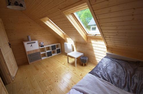 a room with a bed in a wooden house at Michałówka Zawoja in Zawoja