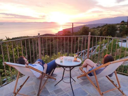 a group of people sitting in chairs on a patio at Lagou Raxi Country Hotel in Lafkos