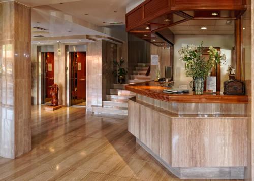 a lobby with a reception counter in a building at Hotel Piedra in Perlora