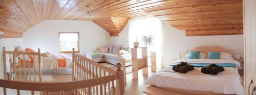 a bedroom with a large bed and a wooden ceiling at Hiška sprostitve in Vransko