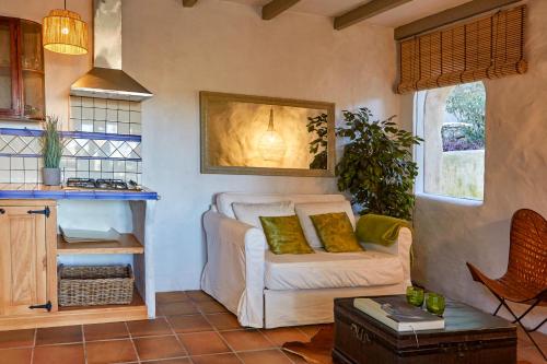 a living room with a white couch and a table at Casa Jasmin at Masia Nur Sitges, Adults only in Canyelles