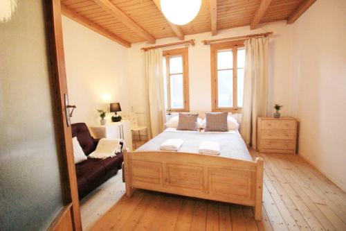 - une chambre avec un grand lit et un canapé dans l'établissement Apartament BazaTatry Taternicki, à Zakopane