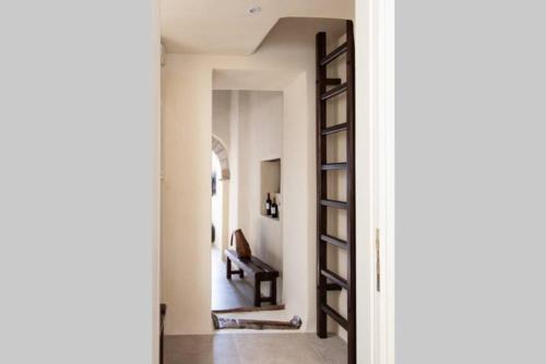 a hallway with a spiral staircase in a house at Petrino Naxos in Naxos Chora