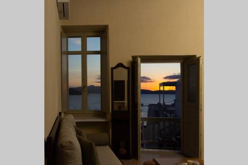 a living room with a couch and a mirror at Petrino Naxos in Naxos Chora