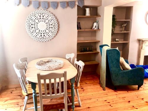a dining room with a table and chairs at Spaven Mor, Near Penzance Stations, 3 bedroom home in Penzance