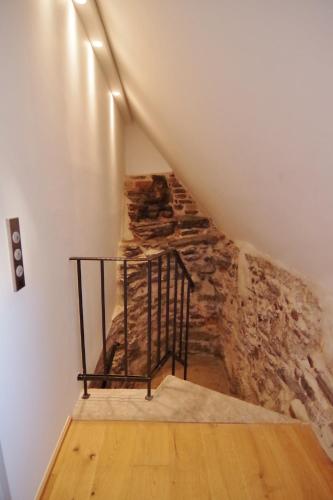 a staircase in a room with a stone wall at Hotel Regent Tallinn in Tallinn