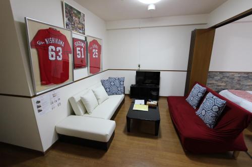 a living room with a couch and a chair at Laforet Tokaichi in Hiroshima