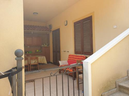 a balcony with a staircase and a living room at Appartamenti Villa Wanda in Palmi