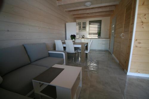 a living room with a couch and a table at Ośrodek Daglezja in Kołczewo