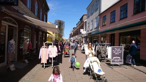 a group of people walking down a street at Frederiksværk Camping & Hostel in Frederiksværk