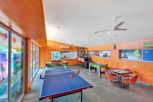 a classroom with ping pong tables and ping pong balls at Club Mahindra Puducherry in Pūrnānkuppam