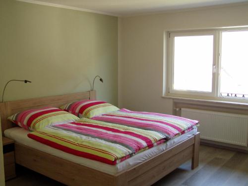 a bed with two pillows on it in a bedroom at Weinhaus Lenartz-Bleser in Briedern