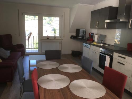 a kitchen with a table and chairs in a room at Weinhaus Lenartz-Bleser in Briedern