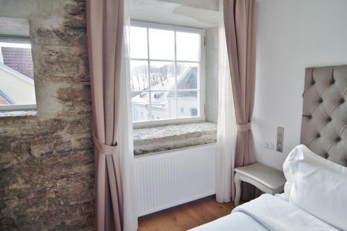 a bedroom with a bed and a window at Hotel Regent Tallinn in Tallinn