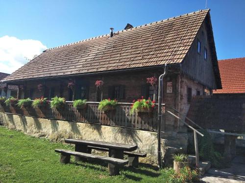 a building with a bench in front of it at Tourist Farm Pri Martinovih in Krška Vas
