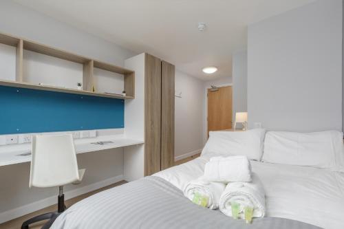 a bedroom with a bed with towels on it at ALTIDO Affordable Edinburgh - Adults only in Edinburgh