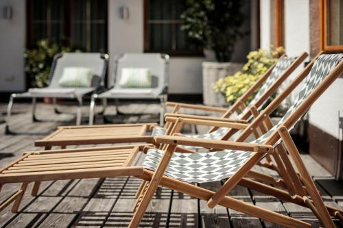 a group of lawn chairs sitting on a patio at Hotel Stäfeli in Lech am Arlberg