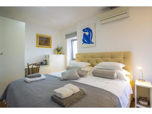 a bedroom with a large bed with two pillows on it at Palace Tower View in Split