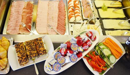 a bunch of different types of food on a table at Familienhotel nahe der Therme Erding in Erding