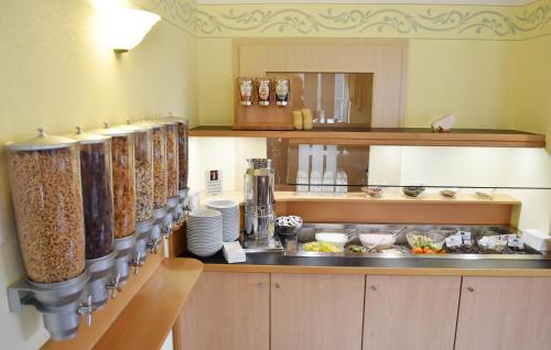a kitchen with a counter with food on it at Familienhotel nahe der Therme Erding in Erding
