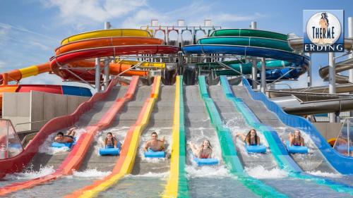 a group of people in a water slide on a water park at Familienhotel nahe der Therme Erding in Erding