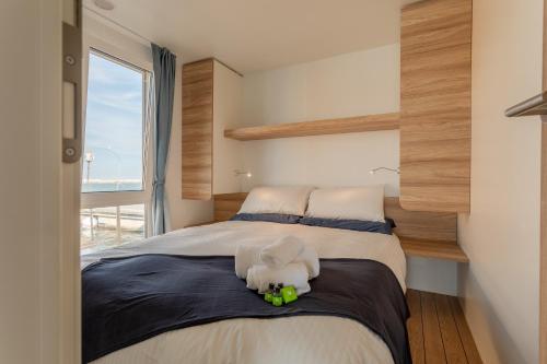 ein Schlafzimmer mit einem Bett mit einem ausgestopften Tier darauf in der Unterkunft AQUA RESORT GIULIANOVA - Houseboat Experience in Giulianova