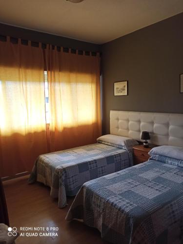 A bed or beds in a room at Hostal La Torre
